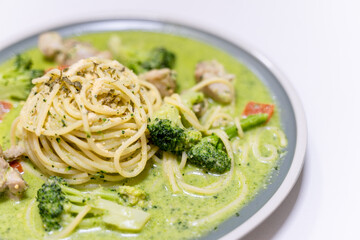 delicious pesto pasta, featuring a rich, green basil pesto sauce. The dish is beautifully presented with fresh ingredients, offering a flavorful and savory experience