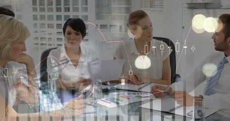 Image of financial graphs over happy diverse businesspeople working