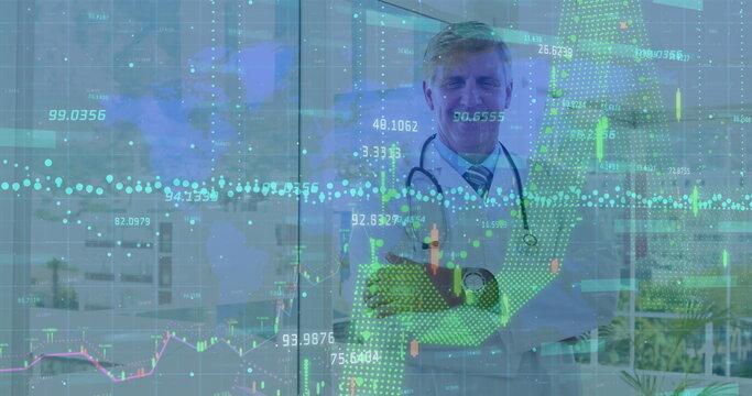 Financial data processing over world map against caucasian senior male doctor smiling at hospital