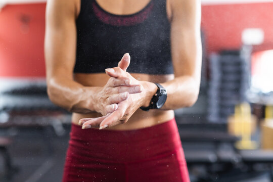 Fit young Caucasian woman prepares for a workout at the gym