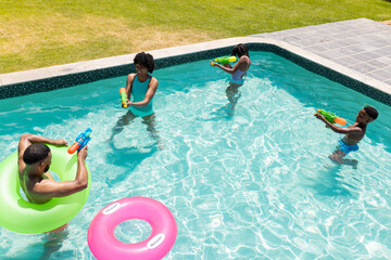 Family enjoys a sunny day in the pool, with copy space