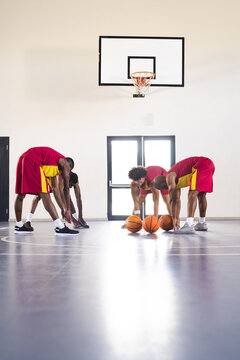 Basketball players strategize on the court, with copy space
