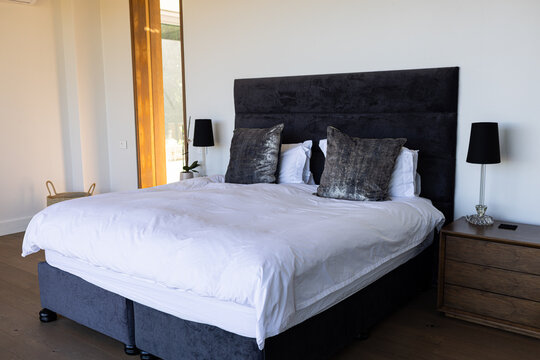A neatly made bed with plush pillows in a modern bedroom
