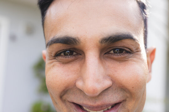 Close-up of a smiling Middle Eastern man outdoors - Powered by Adobe