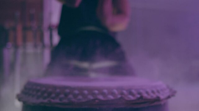 White powder rising while a man is hitting the drum