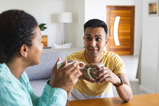 Biracial gay man and Middle Eastern gay man share a moment at home