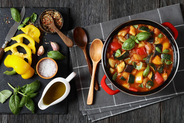 hearty italian vegetable stew in red pot, top view