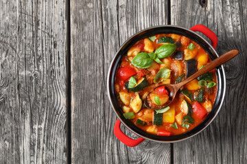 hearty italian vegetable stew in red pot, top view