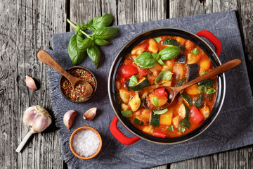 hearty italian vegetable stew in red pot, top view
