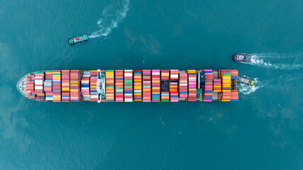 Cargo container ship carrying container and running in the ocean near international container port customs shipyard sea port concept smart logistic service. transportation logistics trading..