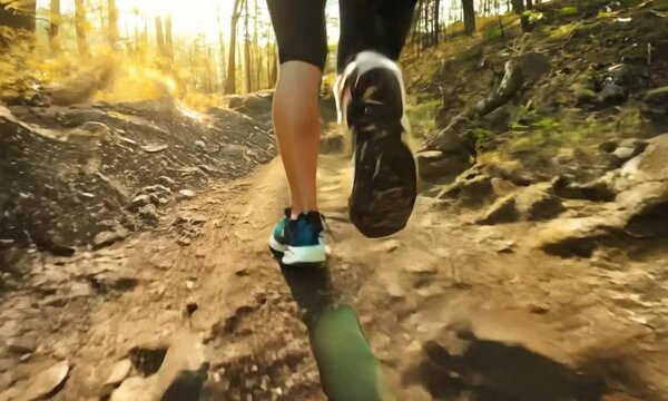 woman climber running in the forest