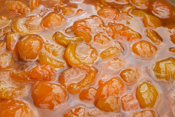 Apricots jam making process. Jam with pieces of apricots. Freshly cooked, hot apricot jam. Close up