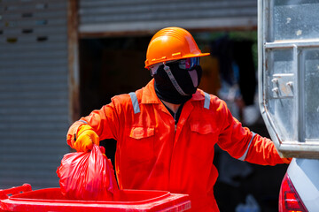 Asian man worker wear protective Infectious waste, Red garbage waste disposal infectious waste...