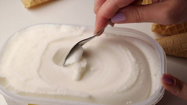 Scoop flavored ice cream vanilla. lemon sorbet  being scooped with an iron spoon, delicious ice cream 