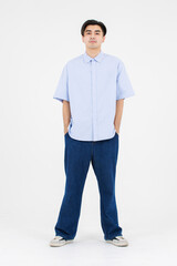 Fototapeta premium Portrait of asian male confidence charming handsome young guy, Wearing blue collar shirt and jeans posing relaxed looking attractive standing on white background studio - isolated