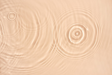 water texture ripples wave clean transparent water abstract background in beige color
