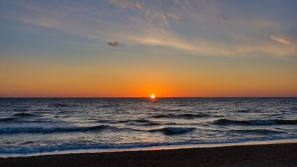 Seascape. The sun is on the horizon. Sea sunset.
