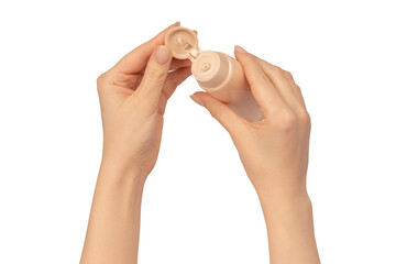 Beige cream tube in woman hands isolated on a white background. Cream swatch on woman hand.