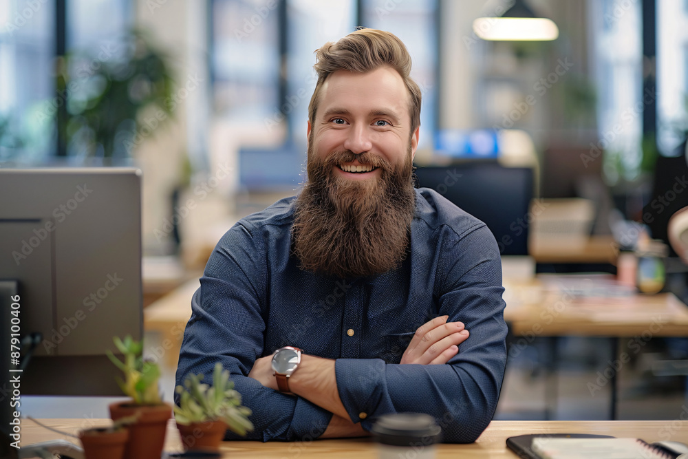 Poster photo of a modern office showing a bearded businessman sitting at his desk with a computer. he is lo