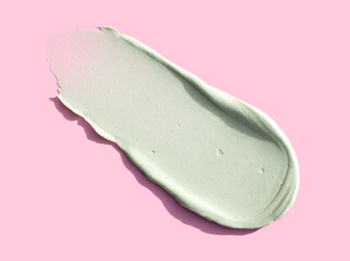 cream texture care cosmetics smear mask peeling green color on pink background skin care concept