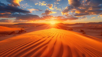 A dramatic desert sunset, the sky ablaze with color and shadows on the dunes