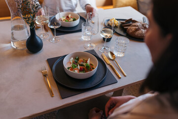 Elegant table setting with gourmet food and wine in a dining area