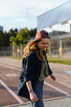 Teenage girl on longboard in the city.