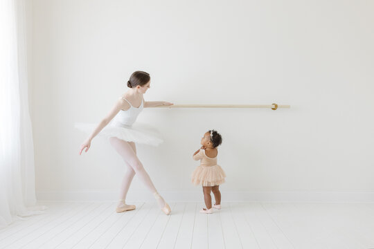 ballerina shows mixed race baby in tutu how to dance