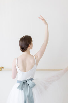 romantic back of ballerina with white tutu and blue bow