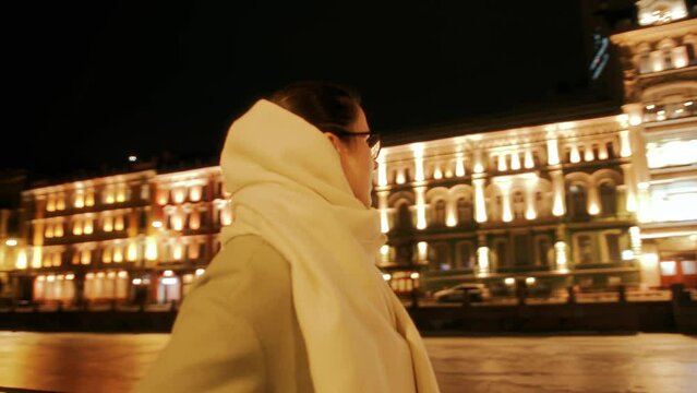 Happy young girl walks along embankment and enjoys views of historical center. Slow motion. Indescribable impressions when visiting beautiful places