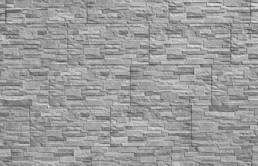 Gray stoneware paneling wall with stone effect. External wall covering. Background and texture.