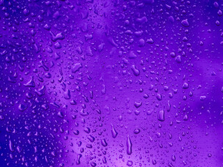 Purple color transparent roof with raindrop and blurred cloud background.