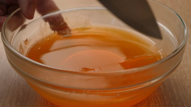The solidified tinted gelatin is cut into cubes. Preparation of gelatin desserts.