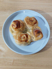 Classic Homemade Ham and Cheese Buns on White Plate