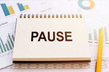Notebook With Pause Next to Pencil