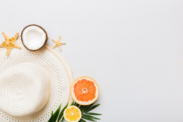 Top view of various seashells placed near colorful fruit and stylish summer accessories on table background. Summer concept. Flat lay. Top view with copy space for text