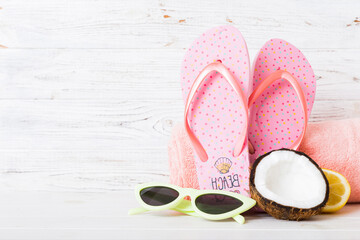 Top view composition of flip flops placed with beach accessories perspective view on table...