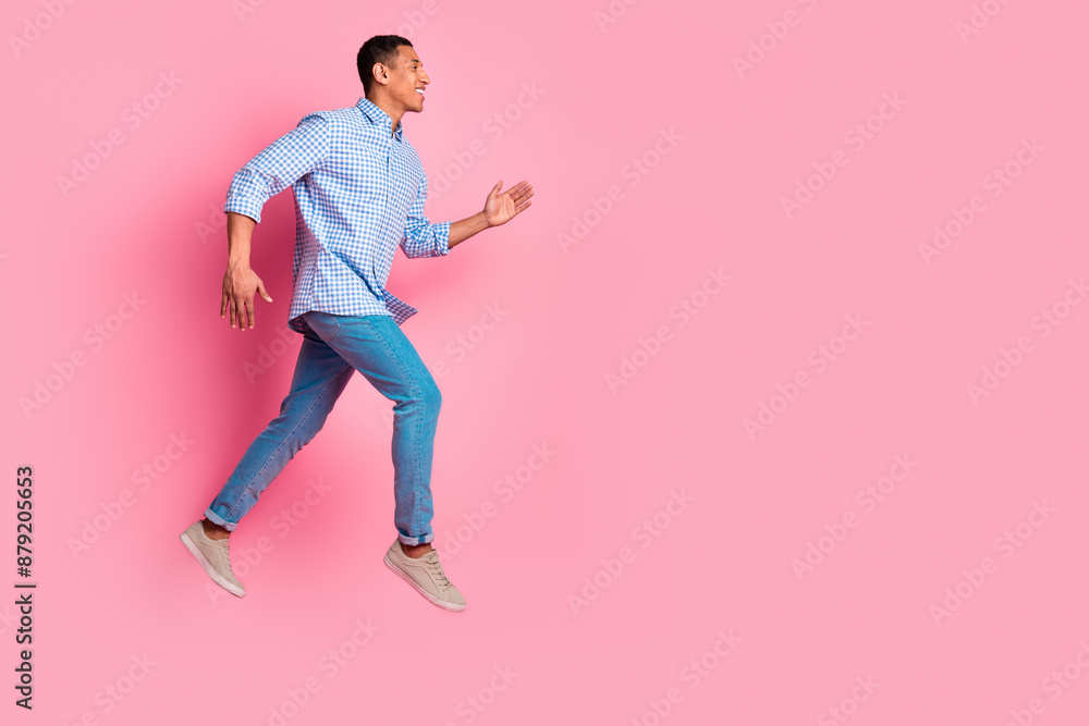 Poster Full length photo of attractive funny guy wear plaid shirt running jumping high emtpy space isolated pink color background