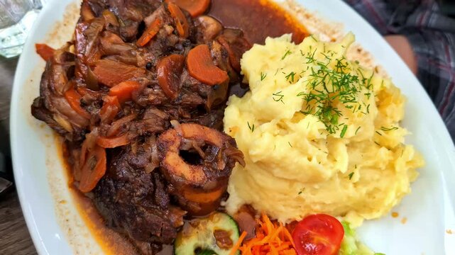 Beef Ossobucco Served With Polenta And Vegetables On Side. Lombard Cuisine. closeup, zoom-out