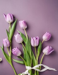 Fototapeta premium Orange Tullips on Orange Background - Beautiful Flowers for Spring - Colored Tullips - Background for Mother's Day, Woman's Day, Valentine's Day or Birthday - Space for Copy or Text