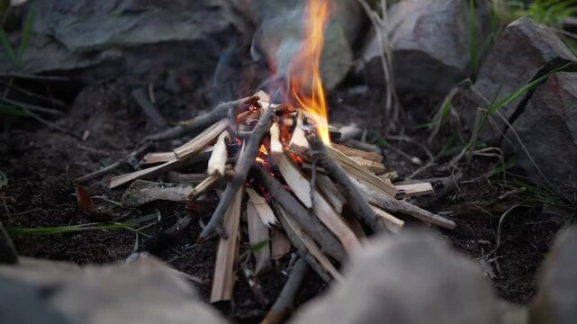 starting bushcraft fire Campfire in a fire pit in the woods