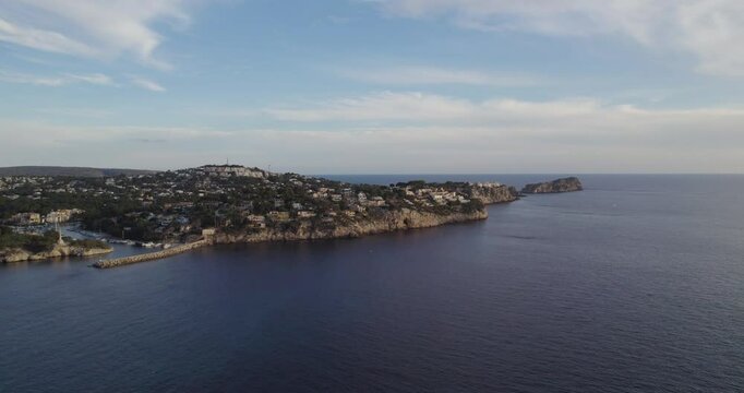 Distant View Of Malgrats Island And Mediterranean Coast At Dusk In Mallorca, Spain. wide aerial shot