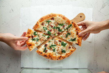 Authentic pizza florentine italian from naples - lifestyle with people and hands.