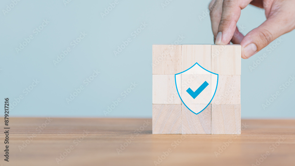 Poster hand put a wooden cube block with identity proof icon for security protection system on wood table. 