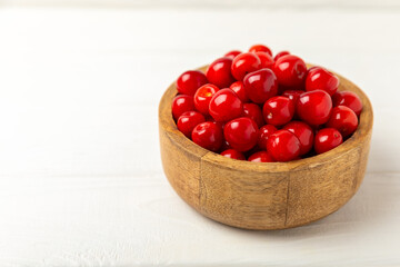 Cherries. Fresh ripe cherries with leaves on a textured wooden background. Fresh sweet organic cherry pile. Berries and fruits. Vegan. Healthy eating. Place for text. Copy space