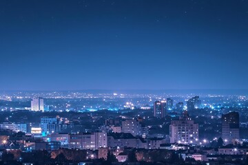 Fototapeta premium A stunning cityscape at night, with twinkling lights and a clear starry sky