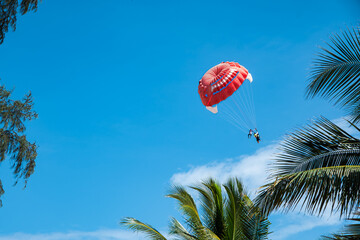 People with parachute. Parasailing. Colorful parasailing parachute with people in Phuket beach Thailand during summer