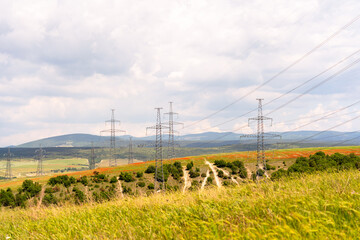 High voltage towers Electric pole. Power line support with wires for electricity transmission. High voltage grid tower with wire cable at distribution station. Energy industry, energy saving