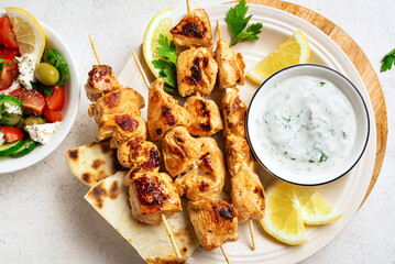 Grilled souvlaki skewers, greek salad and tzatziki