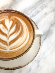 cappuccino coffee with latte art on marble table